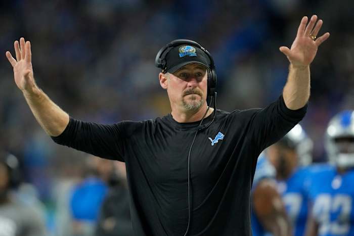 Dan Campbell gestures with two hands up on the sideline during the Lions' win over the Vikings